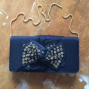 Nina grommet bow gold strap dressy black clutch